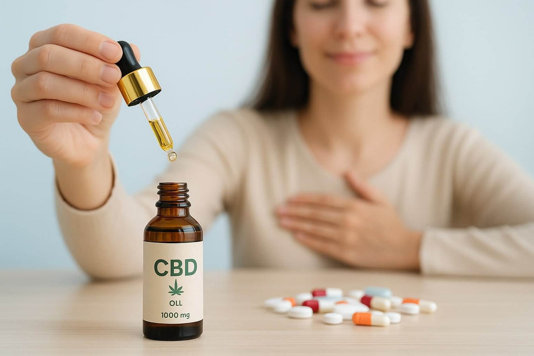 Femme prenant de l’huile de CBD avec des médicaments sur la table, illustrant un possible risque d’interaction.