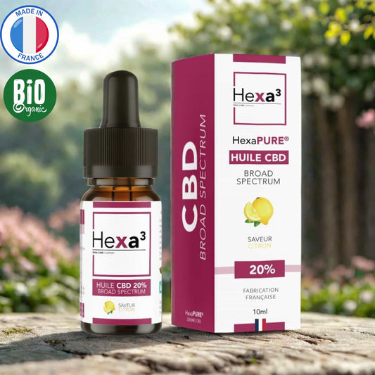 Huile CBD 20% Broad Spectrum saveur citron : flacon pipette ambré et son packaging blanc et bordeaux avec illustration de citron. Made in France, huile MCT bio, 10ml.